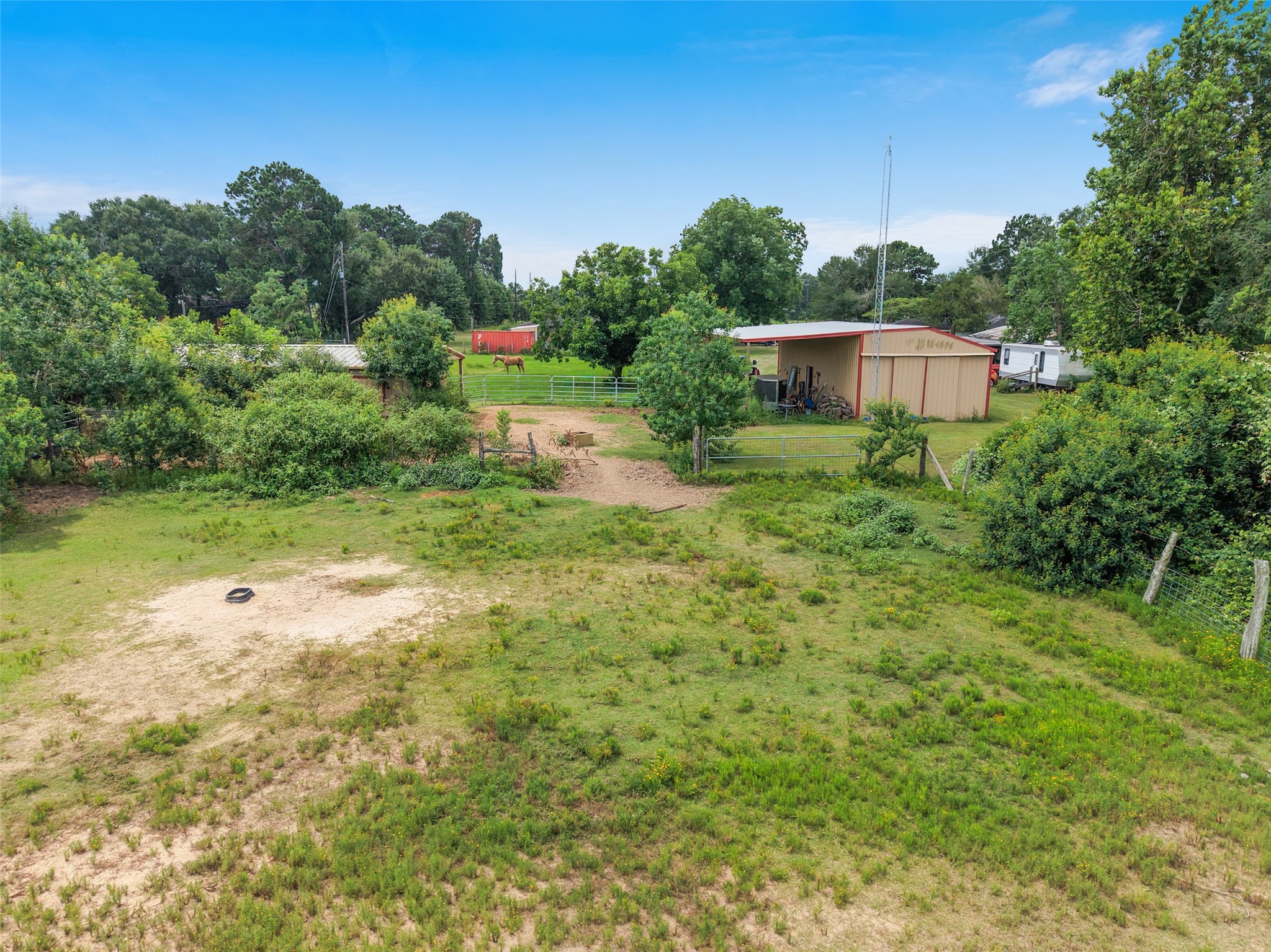 34366 Owens Road Hempstead, TX 77445 - Photo 36 of 46 Spacious fenced backyard with mature trees, open lawn, and plenty of room for outdoor entertaining, gardening, play, or future improvements.