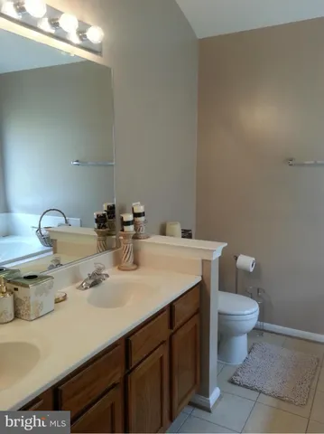 a bedroom with a bed and a dresser next to a window