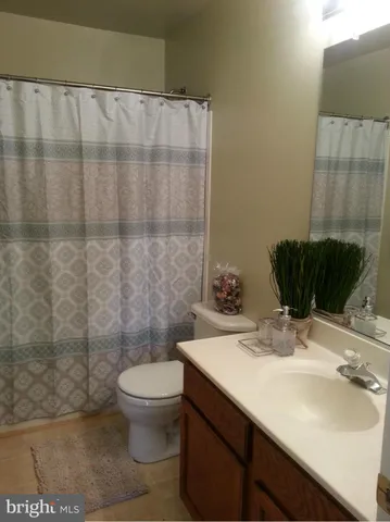 an empty room with windows and flat screen tv