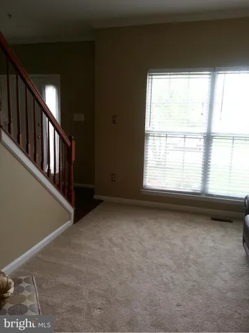 a view of an empty room with windows