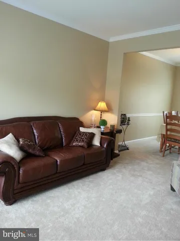 a living room with furniture and a lamp