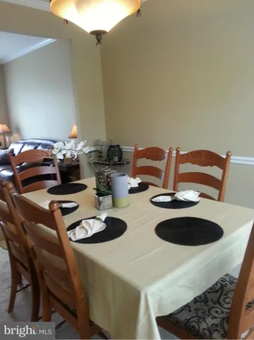a kitchen with a table chairs and stove