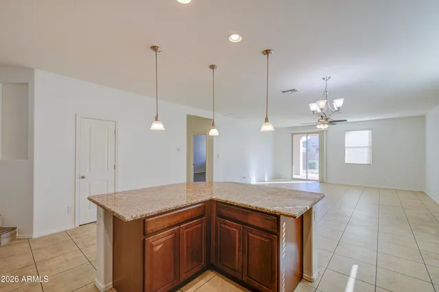 a kitchen with a sink a counter space and a chandelier