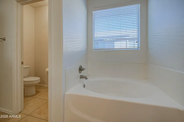 a bath room with a toilet and a bath tub