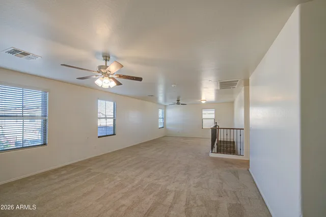 a view of a livingroom with a ceiling fan and window