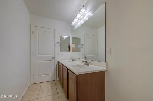 a bathroom with a sink a light fixture and a mirror