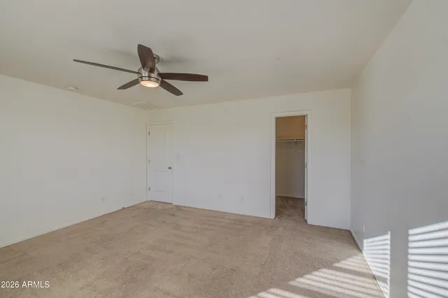 a view of a room with a ceiling fan