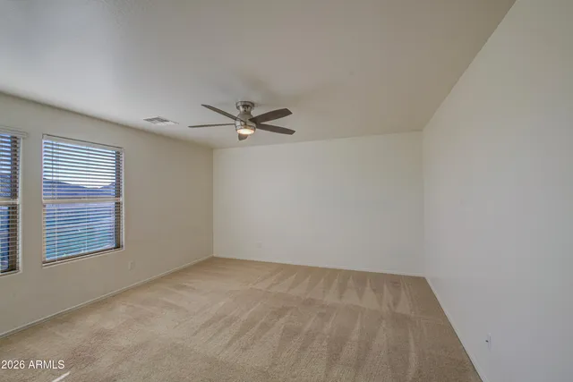 a view of a room with a empty space and a window
