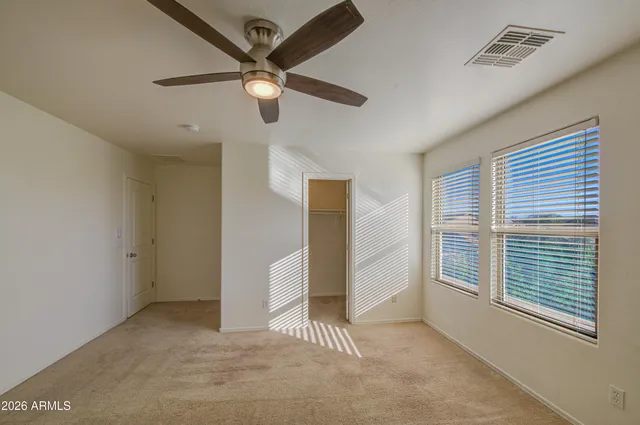 a view of a livingroom with a ceiling fan and window