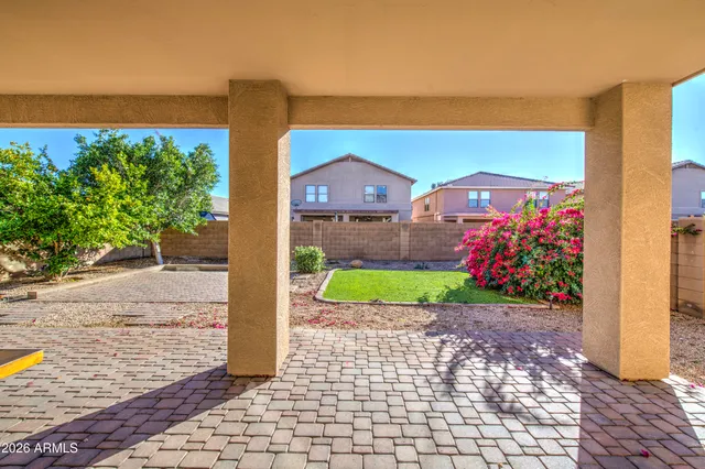 a front view of a house with a yard and potted plants