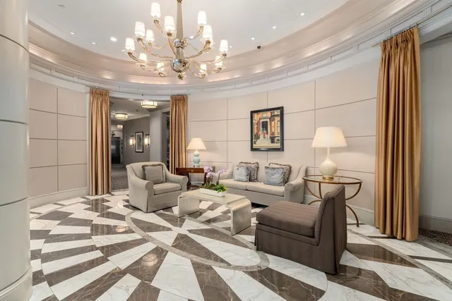 a living room with furniture and a chandelier