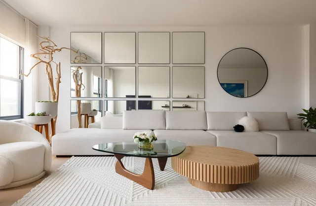 a living room with furniture a rug and a large window