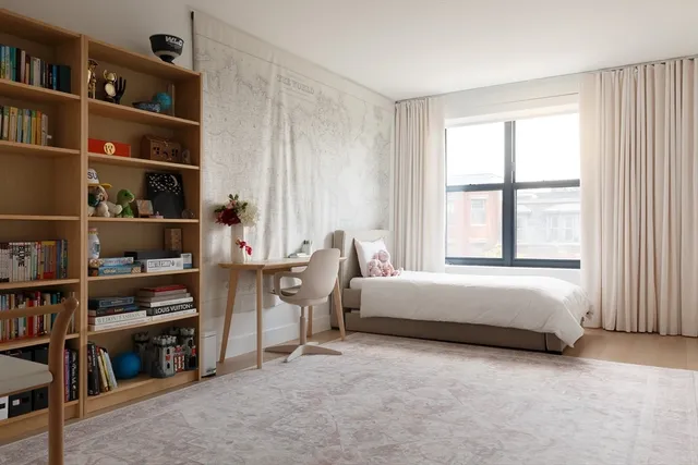 a living room with furniture and a book shelf