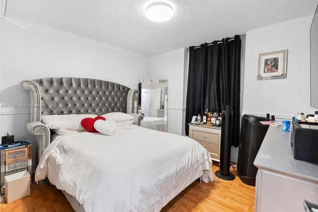 a bedroom with a bed and a television