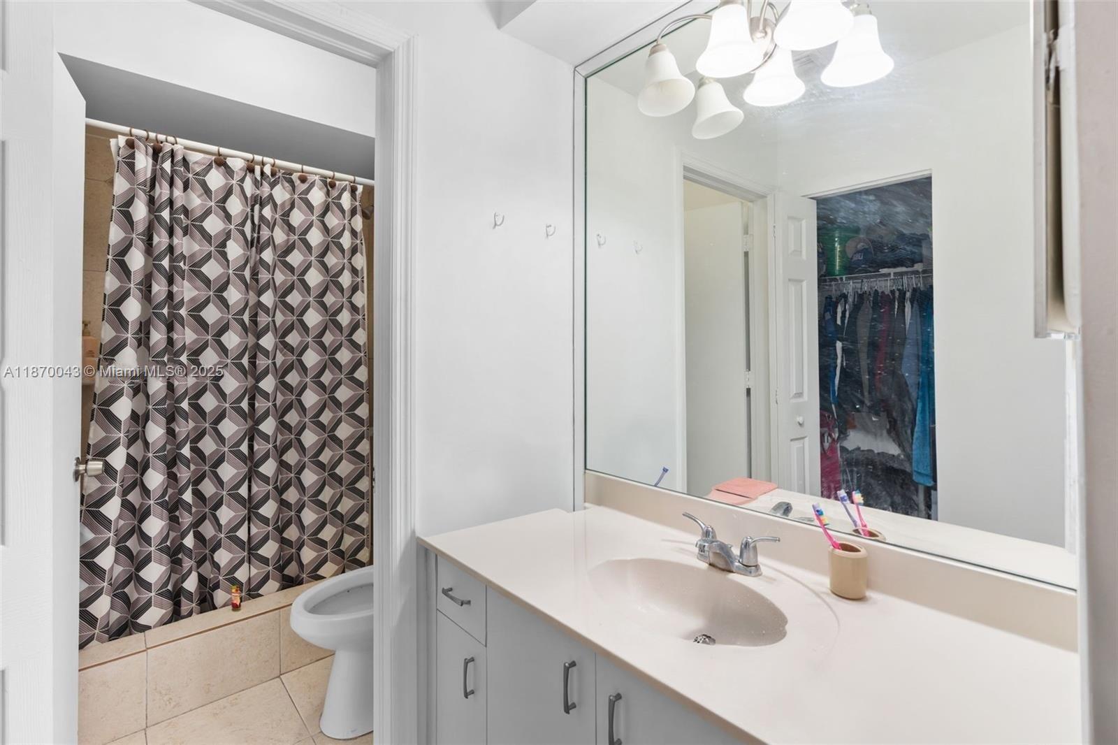 17874 Southwest 114th Avenue Miami, FL 33157 - Photo 12 of 18 a bathroom with a sink a toilet and a mirror