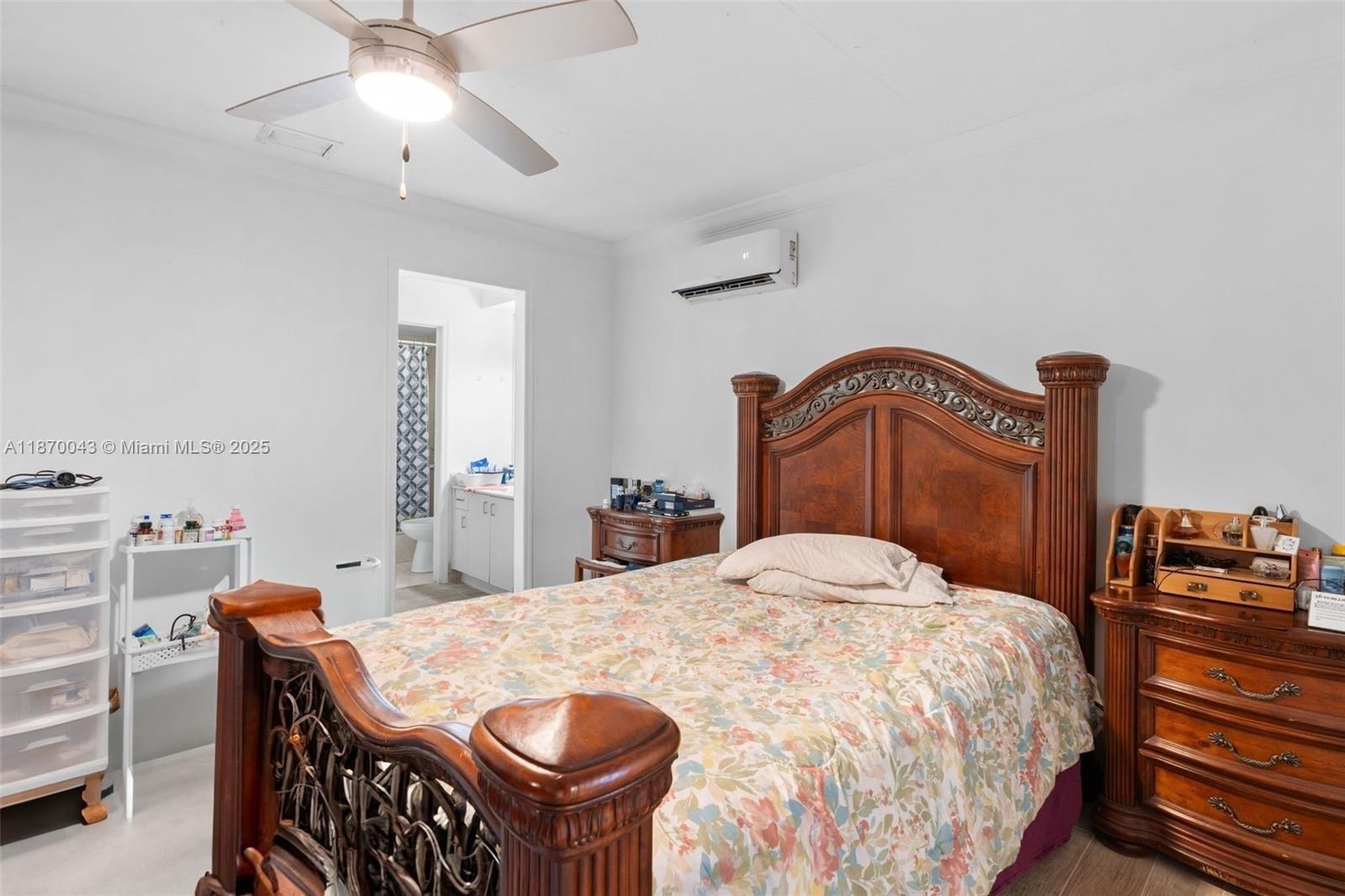 17874 Southwest 114th Avenue Miami, FL 33157 - Photo 14 of 18 a bedroom with a bed and a chandelier