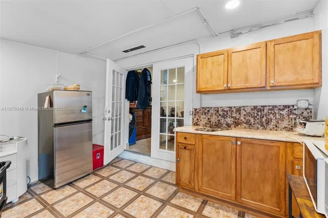 a kitchen with stainless steel appliances granite countertop a refrigerator and a stove top oven