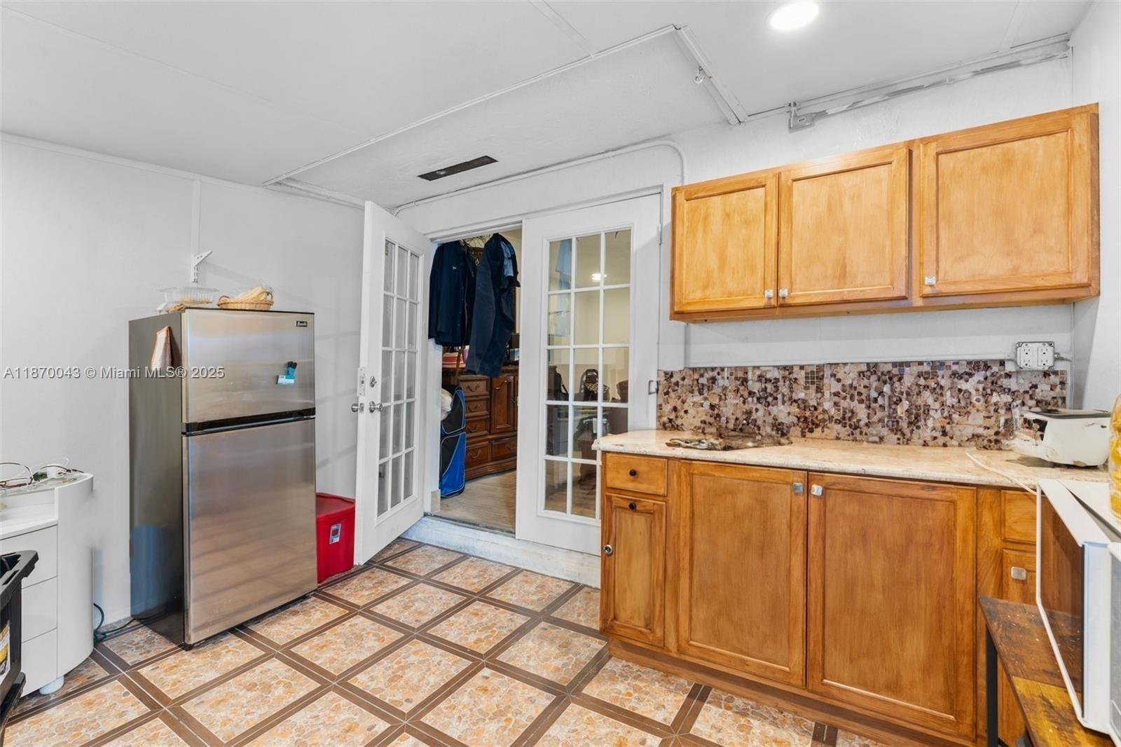 17874 Southwest 114th Avenue Miami, FL 33157 - Photo 15 of 18 a kitchen with stainless steel appliances granite countertop a refrigerator and a stove top oven