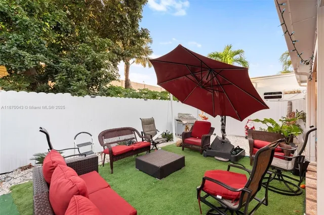 a view of a backyard with furniture and a table