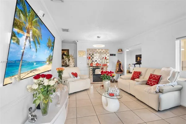a living room with furniture and flowers