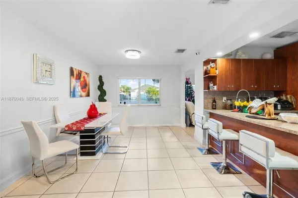 a living room with furniture and dining area