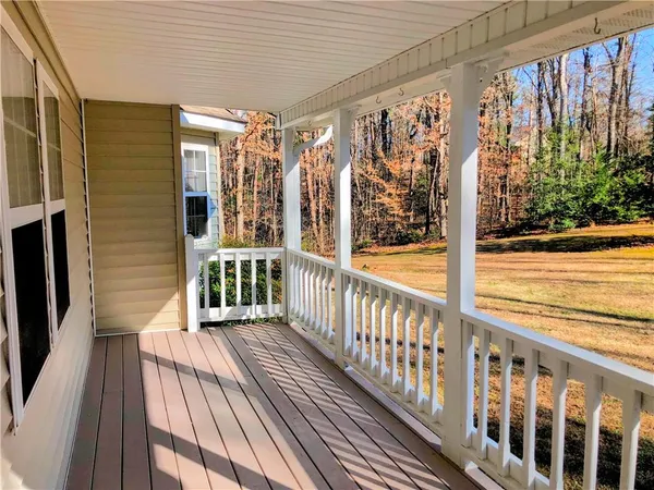 a view of a balcony with wooden floor and outdoor space