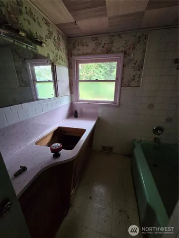 a bathroom with a sink and a window