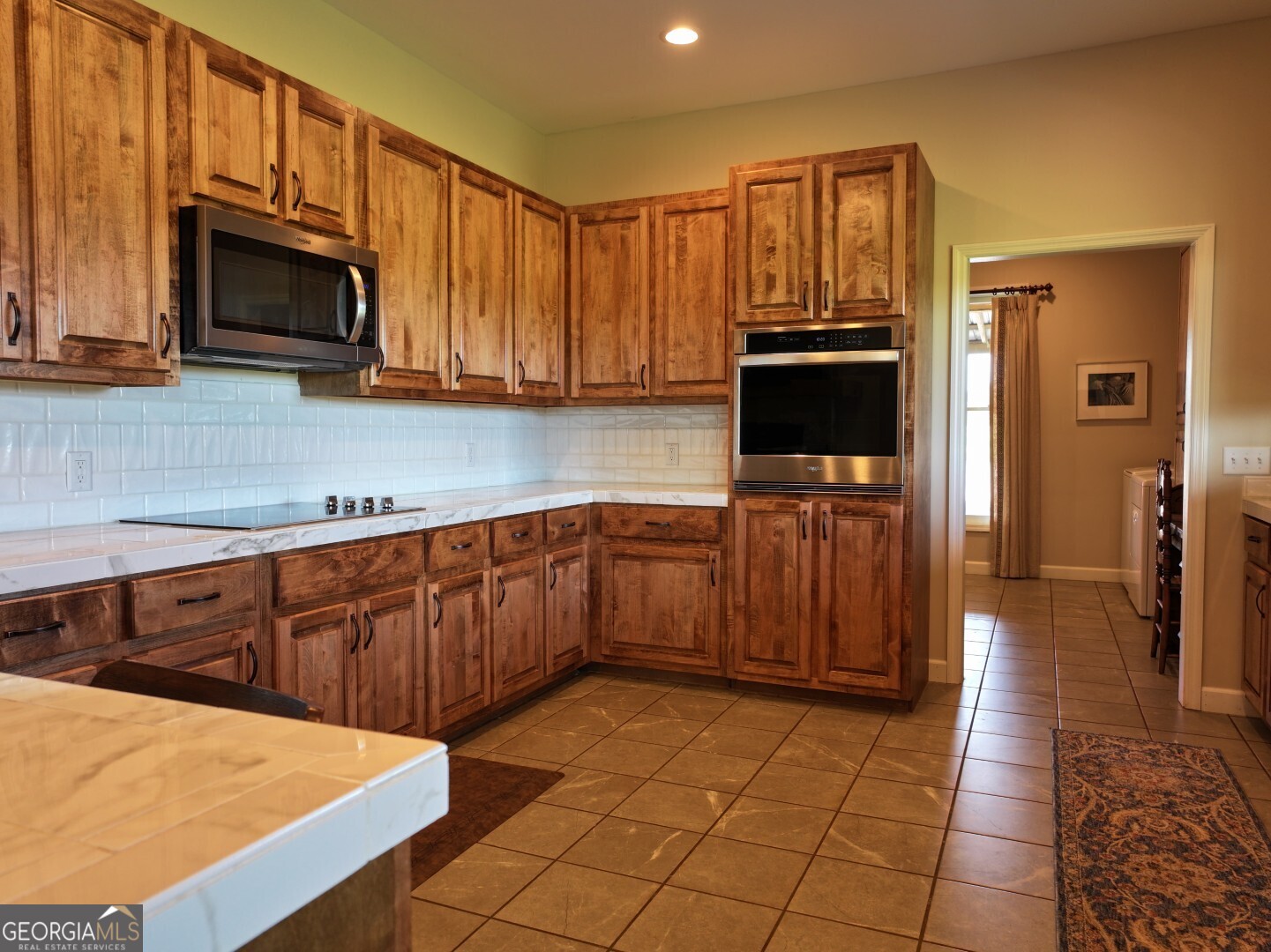 1412 Clark Road Blakely, GA 39823 - Photo 18 of 46 a kitchen with stainless steel appliances a stove a microwave a sink and cabinets