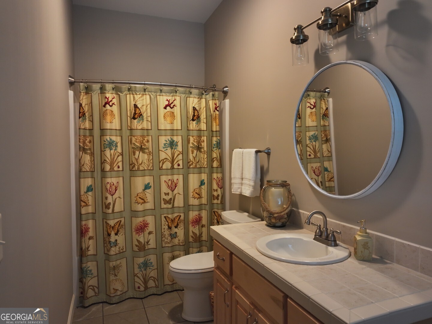 1412 Clark Road Blakely, GA 39823 - Photo 26 of 46 a bathroom with a granite countertop toilet a sink and a mirror