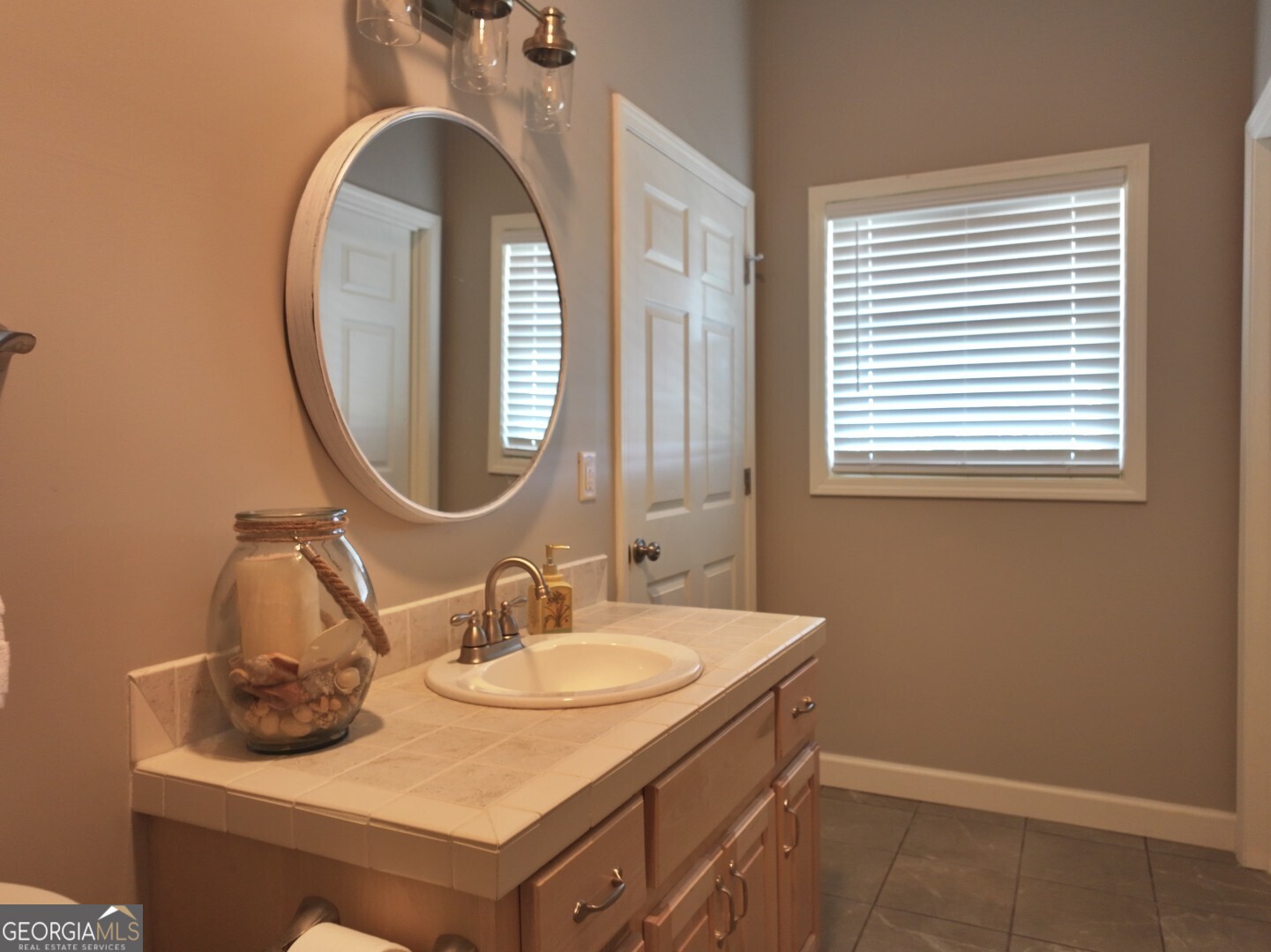 1412 Clark Road Blakely, GA 39823 - Photo 27 of 46 a bathroom with a sink and a mirror