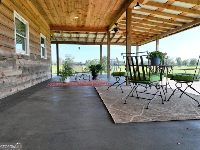 a living room with dining room and kitchen view