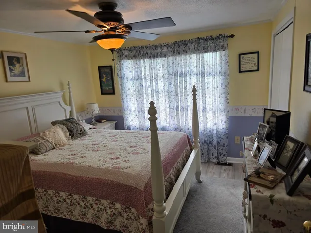 a bed room with a bed and a chair