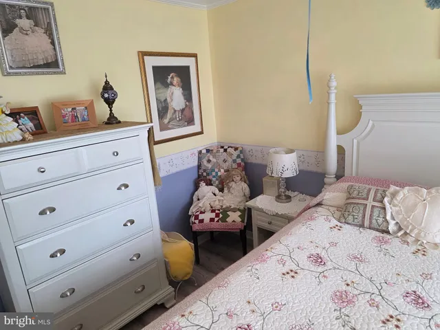 a bedroom with two beds and painting on the wall