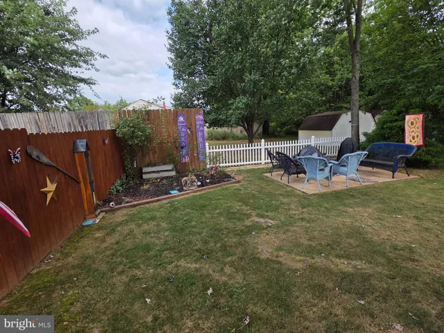 a view of a chair and table in backyard