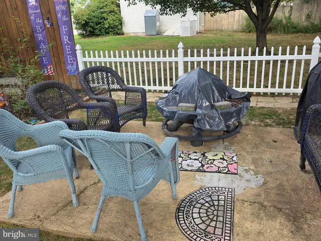 a view of a chairs and table in backyard