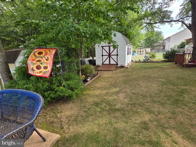 a backyard of a house with lots of green space and fountain