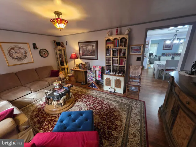 a living room with furniture a rug and white walls