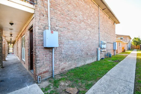 a brick building with a bench in front of it