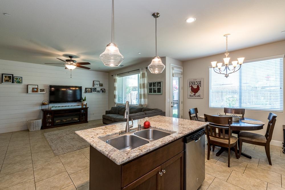 2731 Griffith Avenue Clovis, CA 93611 - Photo 21 of 34 a kitchen with granite countertop a sink and a living room view