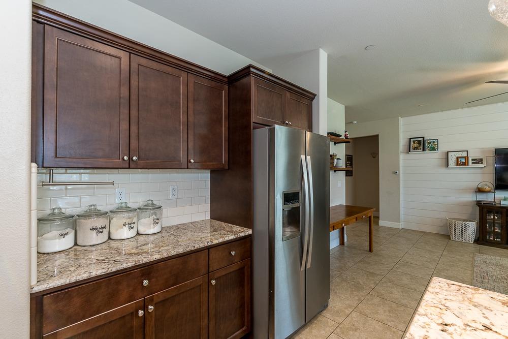 2731 Griffith Avenue Clovis, CA 93611 - Photo 22 of 34 a kitchen with granite countertop stainless steel appliances a refrigerator and a sink