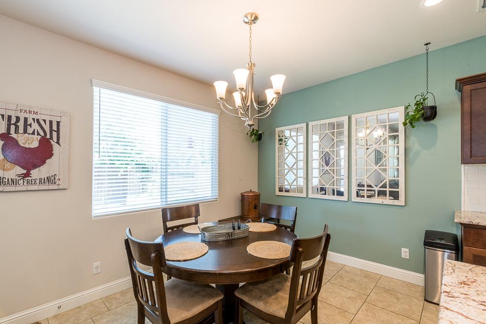 2731 Griffith Avenue Clovis, CA 93611 - Photo 25 of 34 a dining room with furniture a chandelier and window