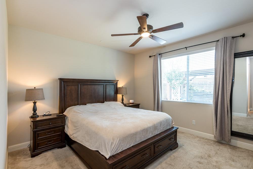 2731 Griffith Avenue Clovis, CA 93611 - Photo 26 of 34 a bedroom with a bed chandelier and a window