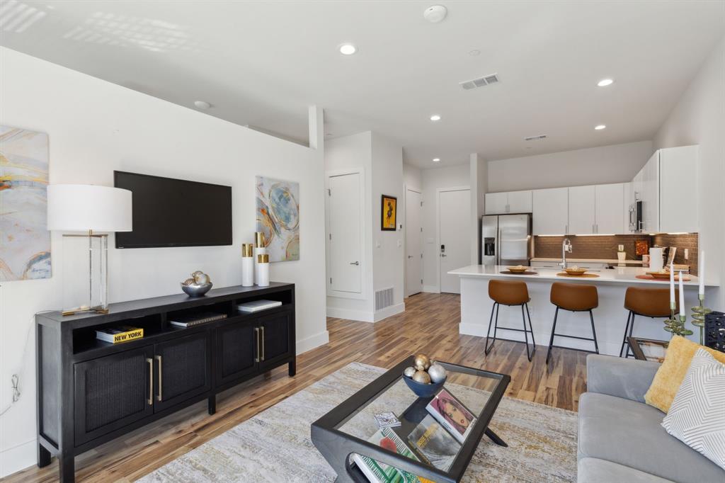 a living room with lots of furniture and kitchen view