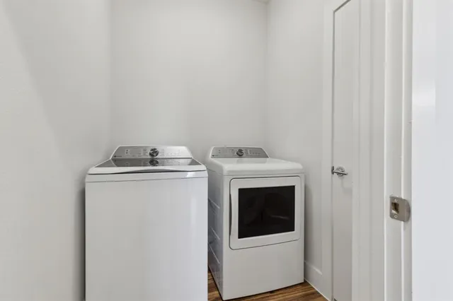 a view of a kitchen with a sink dishwasher and wooden floor