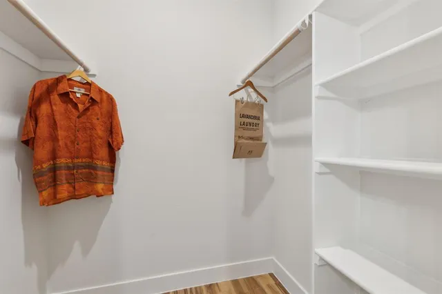 a bathroom with a shower sink vanity mirror and toilet