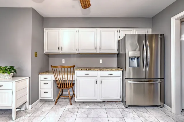 a kitchen with stainless steel appliances granite countertop a refrigerator sink and cabinets