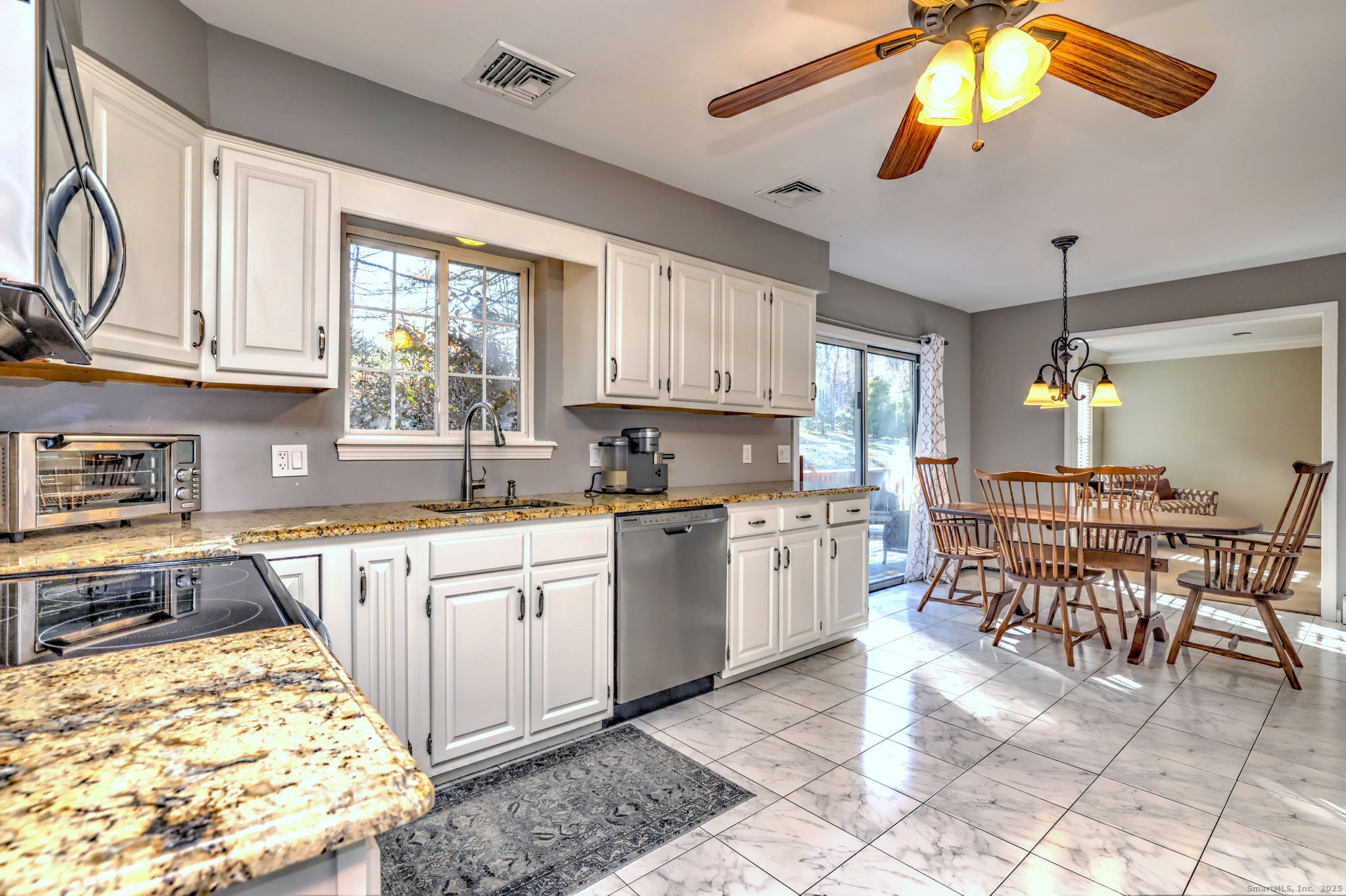 238 Turkey Roost Road Monroe, CT 06468 - Photo 16 of 34 a kitchen with stainless steel appliances granite countertop a stove top oven a sink a dining table and chairs with wooden floor