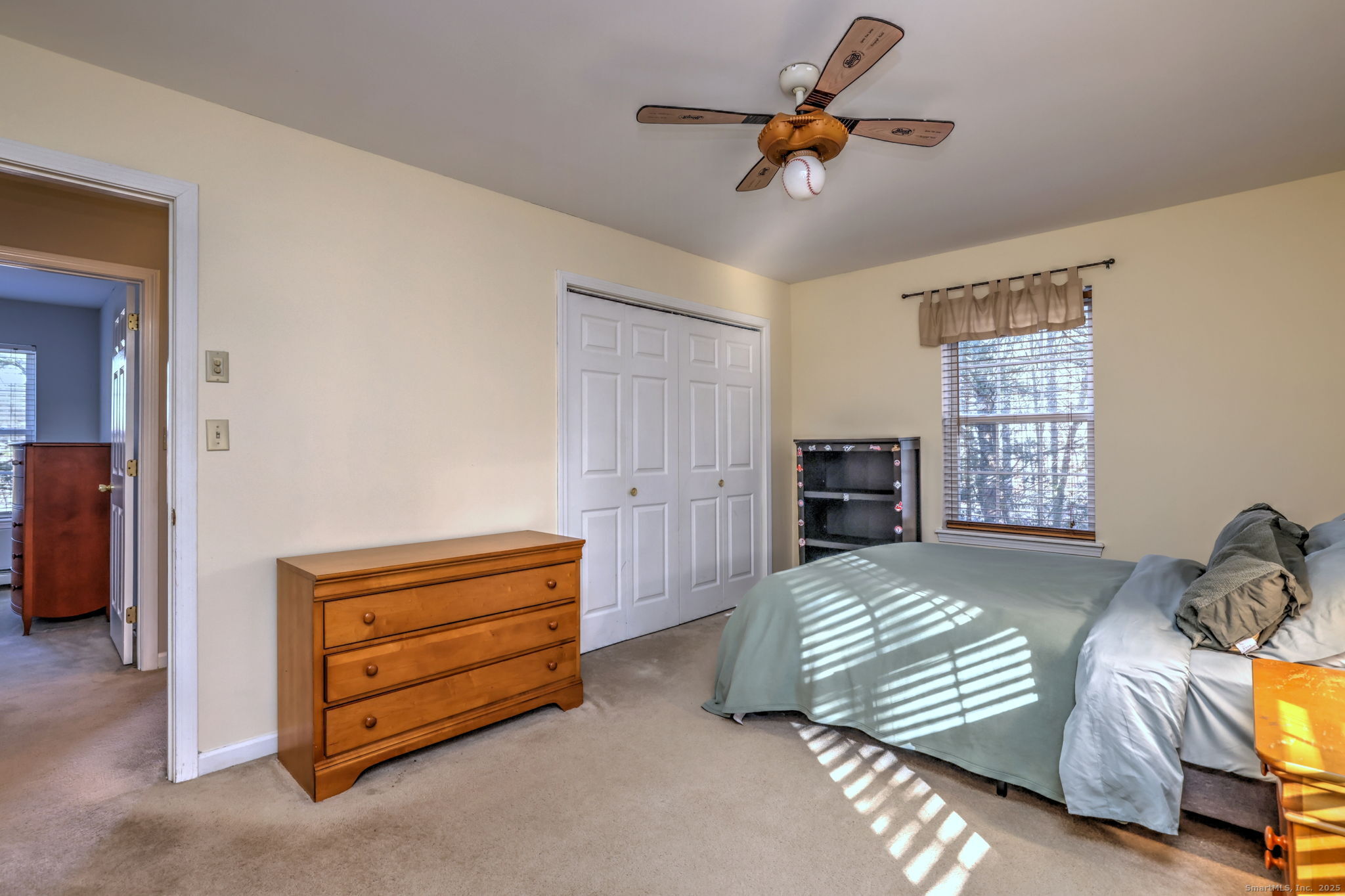238 Turkey Roost Road Monroe, CT 06468 - Photo 25 of 34 a bedroom with a bed and a chandelier