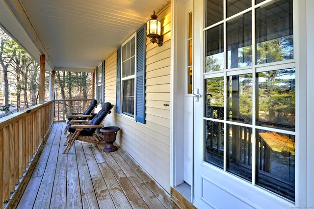 a view of a balcony with chair and wooden floor