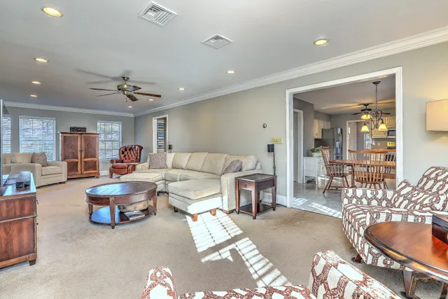 a living room with furniture and view of kitchen